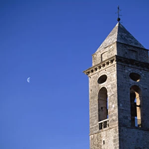 The Belltower Of The Church Of Santo Stefano Di Sessanio With The Moon Behind At Dusk, Abruzzo, Italy