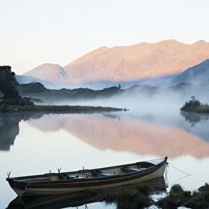 Boat On A Tranquil Lake; Killarney National Park, Killarney, County Kerry, Ireland