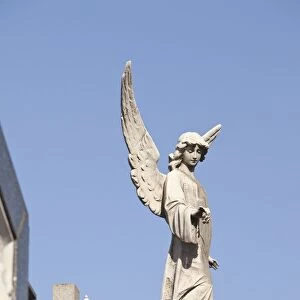 Buenos Aires, Argentina; Angel Statues And A Cross Made Of Stone On Top Of Tombs In The Recoleta Cemetery