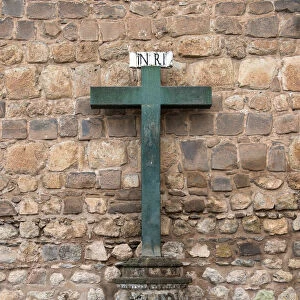 A Green Cross Against A Stone Wall Of Plaza De Armas; Cusco Peru