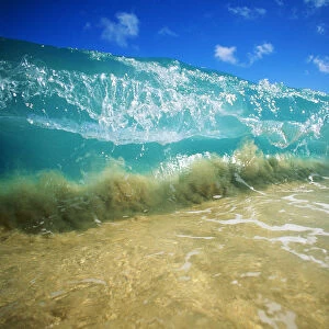 Hawaii, Turquoise Breaking Wave, Sand Visible Through Clear Water, Blue Sky. Close-Up