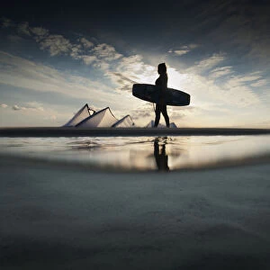 A Kitesurfer Walks Along The Beach At Sunset; Tarifa, Cadiz, Andalusia, Spain