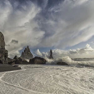 Large Waves Crash Against The Shoreline And Sea Stacks On The Southern Shore Of Iceland, Near Vik; Iceland