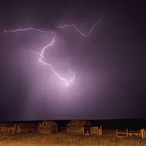 Lightning bolt over some abandoned buildings near val marie; Saskatchewan canada