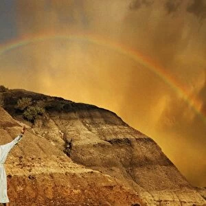 Man With Outstretched Arms, Rainbow In Background