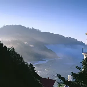Oregon, View Of Heceta Head Lighthouse Early Morning Sun, Tree Covered Mountains