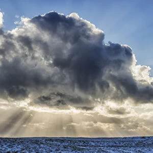 Rays Of Light Shine Out From Behind The Clouds In The Skies Above A Lightnouse Along The Southern Shore Of Iceland; Iceland