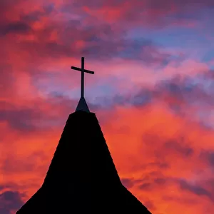 Silhouette Of A Church Steeple With Colourful Clouds And Blue Sky In The Background; Calgary, Alberta, Canada