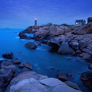 Small Lighthouse And House At Dusk