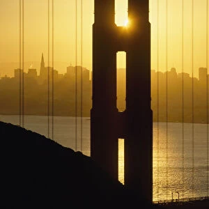 Sunrise Behind The Golden Gate Bridge With Skyline Behind
