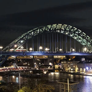 Tyne Bridge Illuminated At Nighttime Over River Tyne With A Crescent Moon In The Sky; Newcastle, Tyne And Wear, England