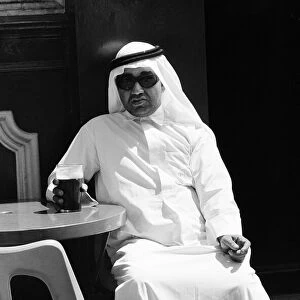 Arab man sitting outside enjoying a pint of Guinness at the Stanhope public house