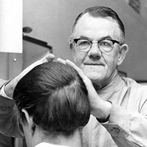 Barber Mr. Fisher hard at work within Bainbridges hairdressing salon in August 1969