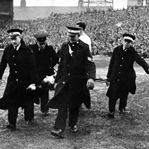 Brian Clough is carried from the field by the St John Ambulance Brigade after injuring