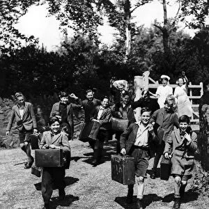 Evacuated children leave with their cases from their Leicestershire home as they head for