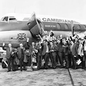 Everton team members wave before their plane bound for Australia departs from Speke