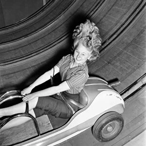 Fun fair - Jean Baker on one of the rides at the festival gardens Battersea. April 1953