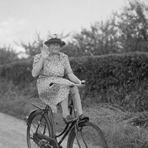 Mrs Hilda Baker seen here coasting downhill on her bicycle with her feet up on the front