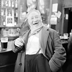A shipyard worker seen here enjoying a whisky chaser and a pint after knocking off work