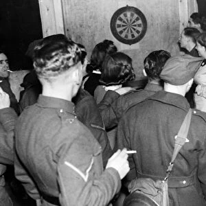 Soldiers play darts at the Wayfarers Club with local girls in Liss, Hampshire