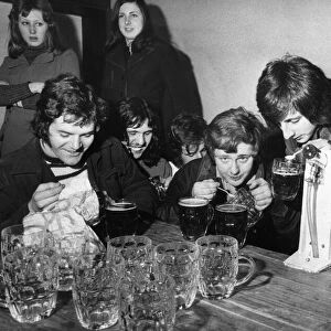 Students of Manchester University of UMIST take part in a beer drinking competition using