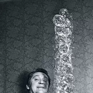 Waiter Johnny Zelaskowski holds 50 fragile Wine glasses stacked high March 1978