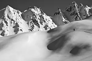 Backcountry Skier Skinning In The Iguana Backs Of The Chugach Range Above Valdez Backcountry Skier Skinning In The Iguana Backs Of The Chugach Range Above Valdez
