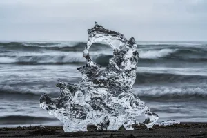 Close-up of a piece of ice with the ocean behind, Iceland Close-up of a piece of ice with the ocean behind, Iceland