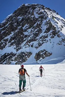 A Couple Telemark Skiing On The Ruth Glacier Near The Don Sheldon Hountain House A Couple Telemark Skiing On The Ruth Glacier Near The Don Sheldon Hountain House