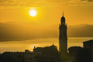 Golden Sky At Dusk With Tower Of Church; San Lorenzo Della Costa, Liguria, Italy Golden Sky At Dusk With Tower Of Church; San Lorenzo Della Costa, Liguria, Italy