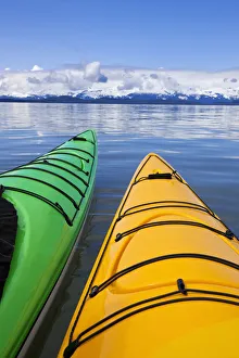 Kayakers enjoy a tranquil morning paddle in Lynn Canal, Alaska, near Juneau Kayakers enjoy a tranquil morning paddle in Lynn Canal, Alaska, near Juneau