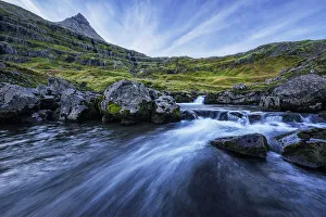 A Mountain Stream Runs Toward The Ocean In The Fjord Called Mjoifjordur, East Iceland; Iceland A Mountain Stream Runs Toward The Ocean In The Fjord Called Mjoifjordur, East Iceland; Iceland
