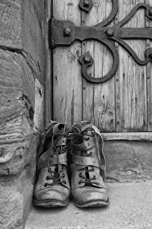 A Pair Of Worn Boots Outside A Door; Northumberland, England A Pair Of Worn Boots Outside A Door; Northumberland, England