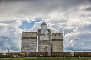 Rural Grain Elevator With Cumulonimbus Clouds Building Up Around It; Saskatchewan, Canada Rural Grain Elevator With Cumulonimbus Clouds Building Up Around It; Saskatchewan, Canada