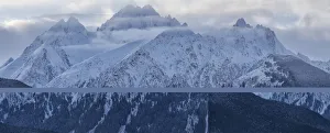 Snow covered majestic mountains with misty clouds hovering at the peaks, Haines, Alaska, USA Snow covered majestic mountains with misty clouds hovering at the peaks, Haines, Alaska, USA