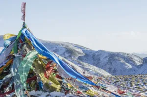 Snowy Landscape With Prayer Flags On A High Altitude Mountain Pass; Tibet Snowy Landscape With Prayer Flags On A High Altitude Mountain Pass; Tibet