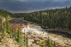 Sunlight Illuminates The Trout River Flows Over Coral Falls; Northwest Territories, Canada Sunlight Illuminates The Trout River Flows Over Coral Falls; Northwest Territories, Canada