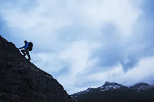 Swiss Biologist And Photographer Climbing On Ridge Line Above Kinak Bay Along Katmai Coast Swiss Biologist And Photographer Climbing On Ridge Line Above Kinak Bay Along Katmai Coast