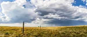 Vast fields of farmland on the prairies under a big sky with clouds and a storm in the distance; Val Marie Vast fields of farmland on the prairies under a big sky with clouds and a storm in the distance; Val Marie