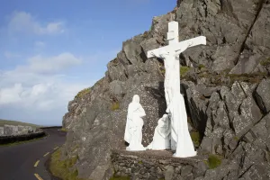 White religious figures standing on a rock beside the road at slea head near dunquin White religious figures standing on a rock beside the road at slea head near dunquin