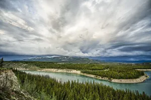 Yukon River with a storm passing overhead while flowing through Whitehorse; Whitehorse, Yukon, Canada Yukon River with a storm passing overhead while flowing through Whitehorse; Whitehorse, Yukon, Canada